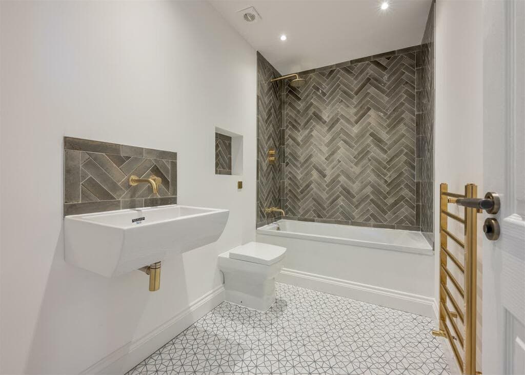 Herringbone-tiled bathroom completed by 1st Boiler Care