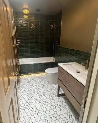 Dark-tiled bathroom installation completed by 1st Boiler Care