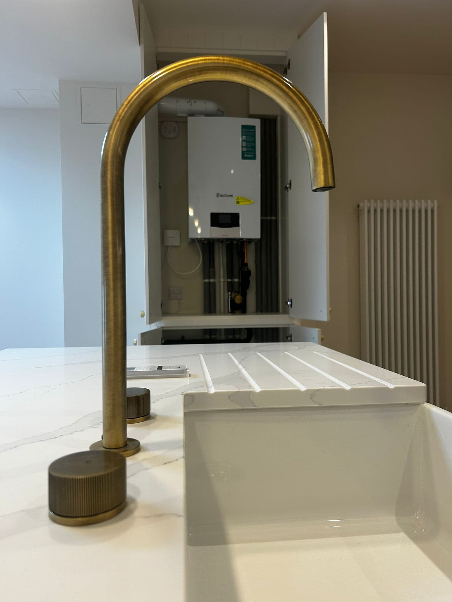 Modern bathroom with brass faucet and boiler installation